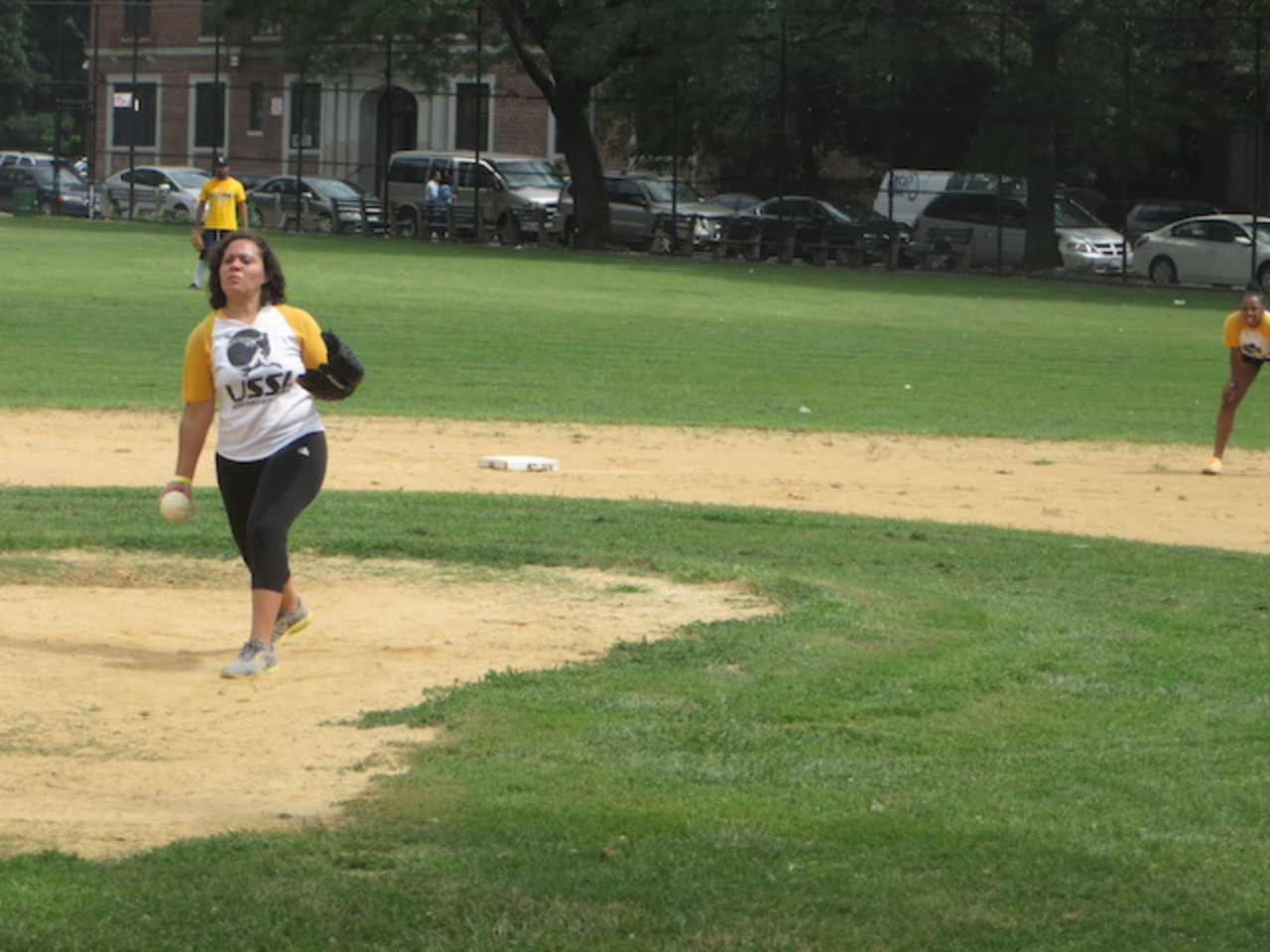 Softball player throwing on field
