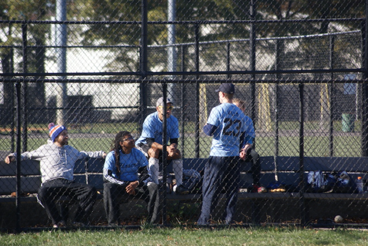 Baseball players resting in dugout