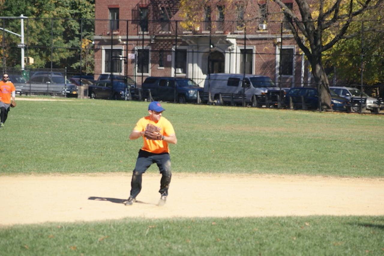 Man playing baseball in sunny park
