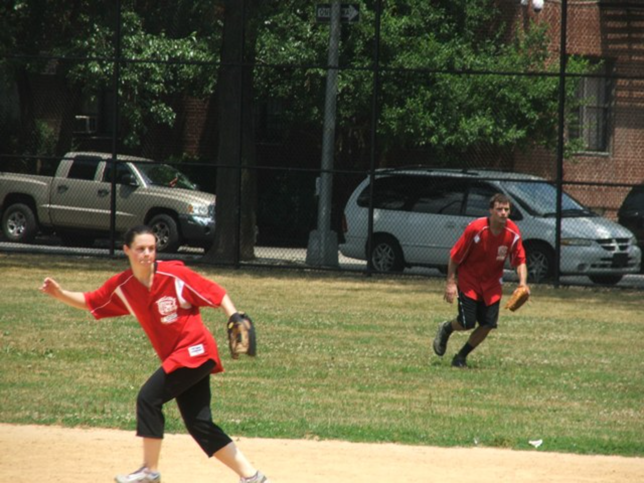 Red team playing baseball outdoors