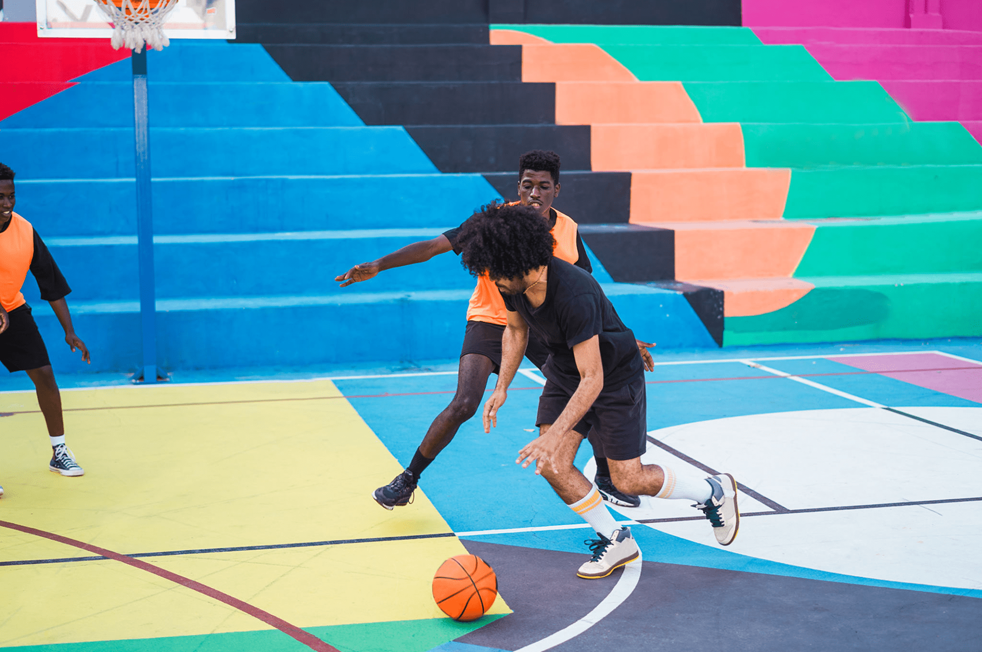 Basketball players on colorful court