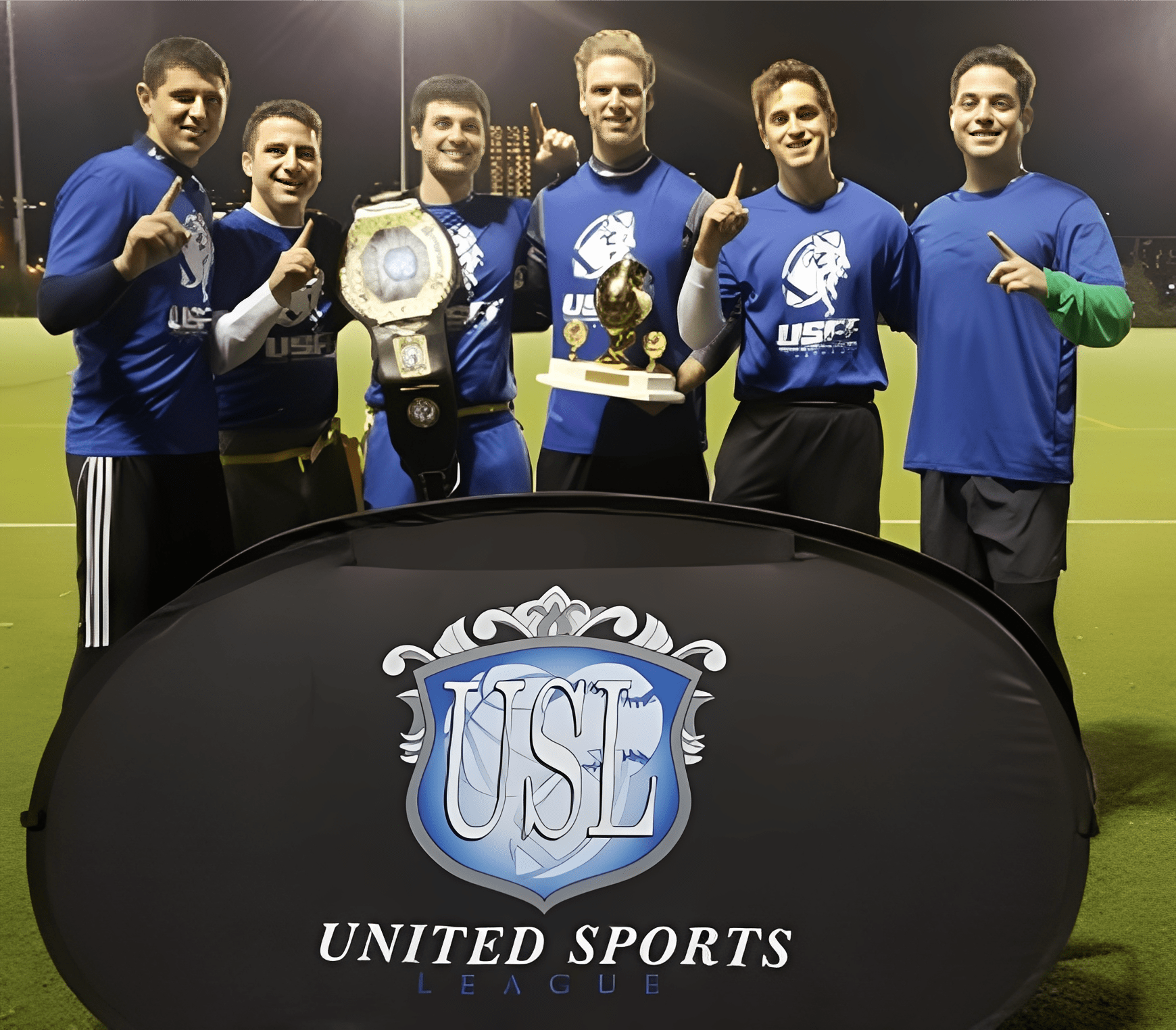 Sports team celebrating with trophies at night