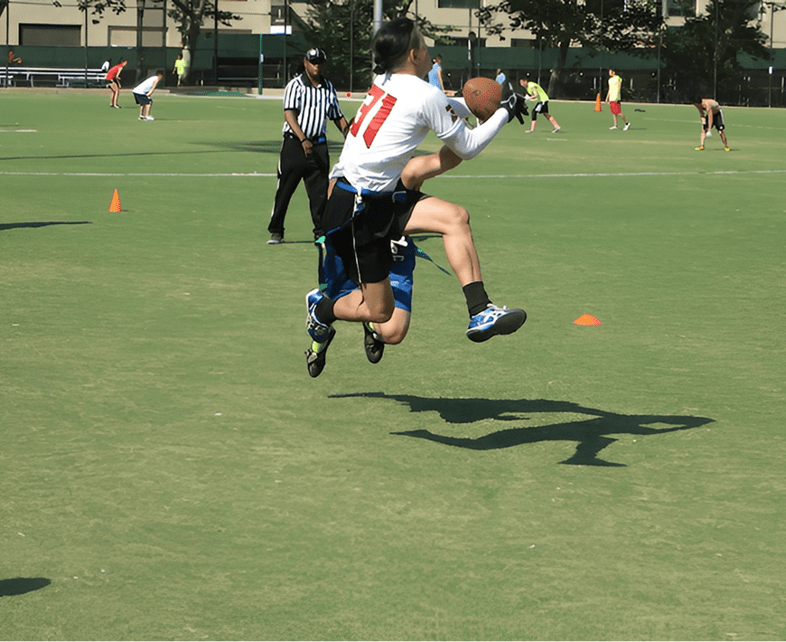 Football player jumping to catch ball