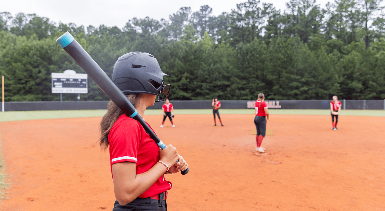 Girls playing softball on field