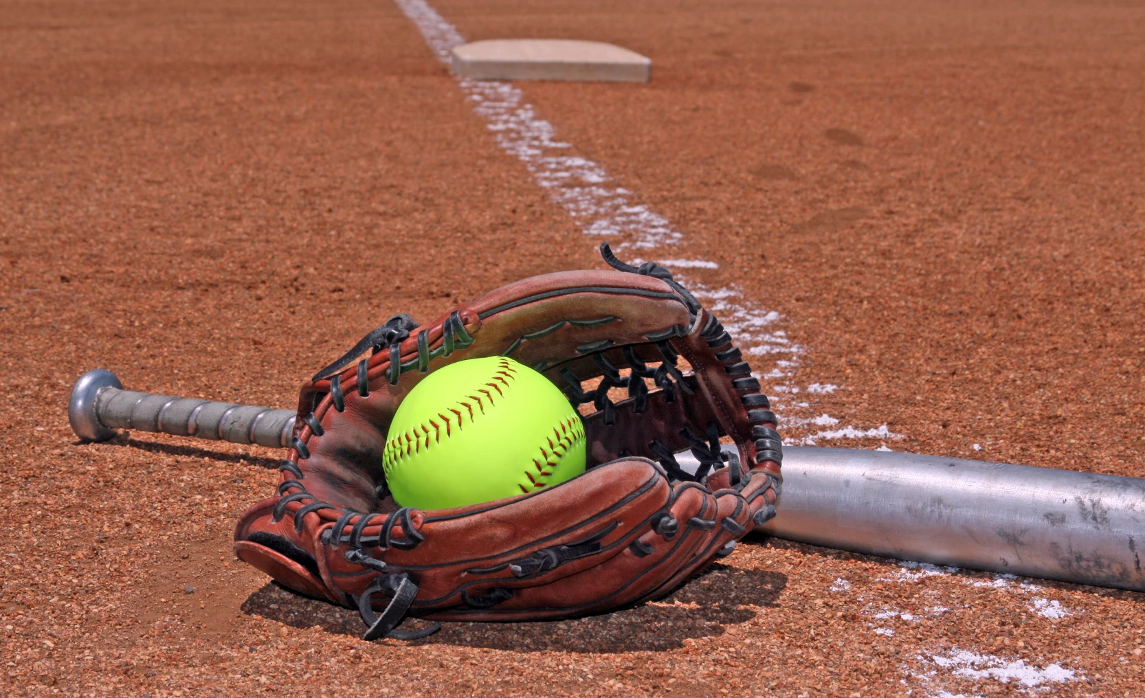 Glove and bat with softball