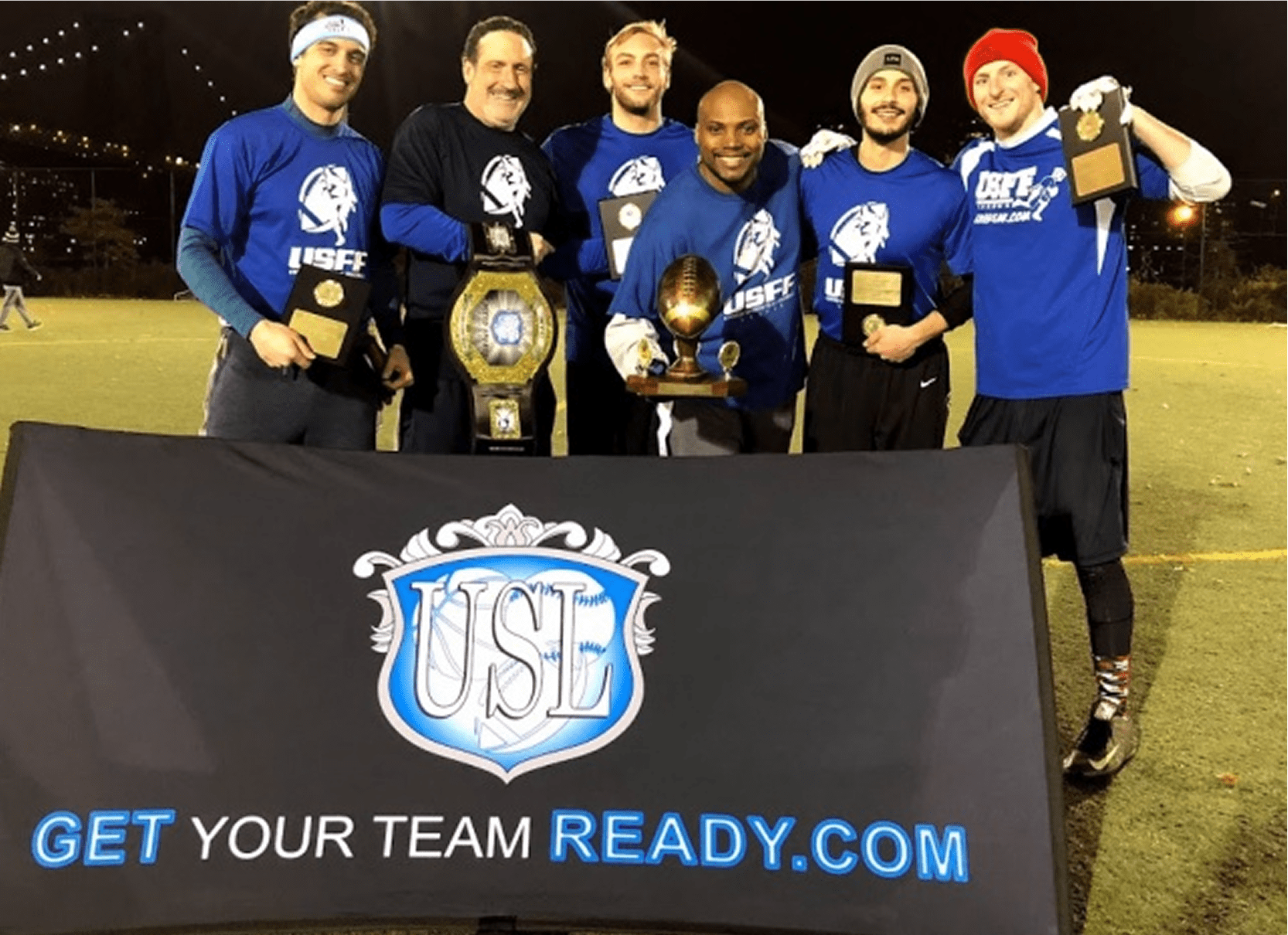 Smiling team with championship trophies