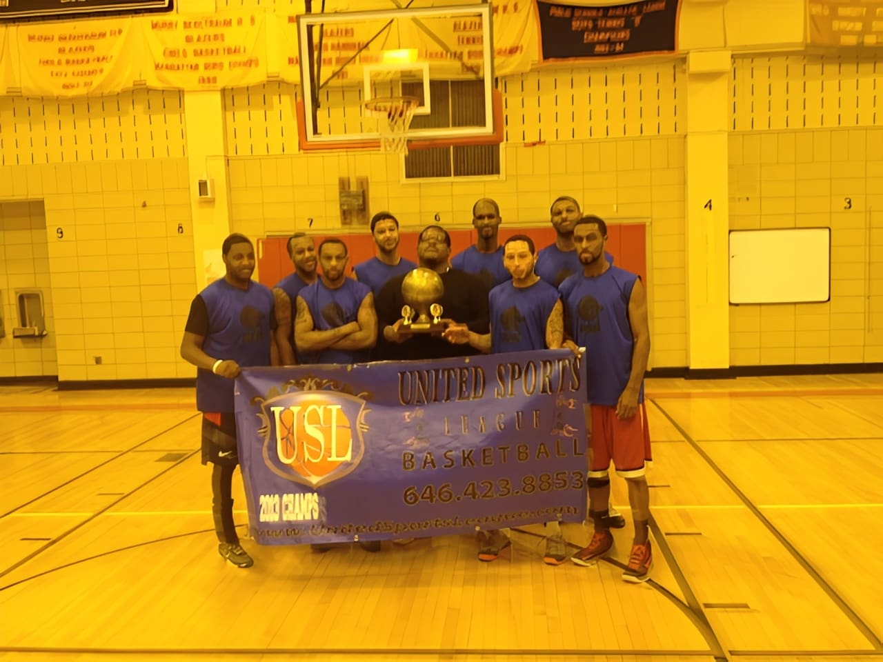 Basketball team holding championship banner