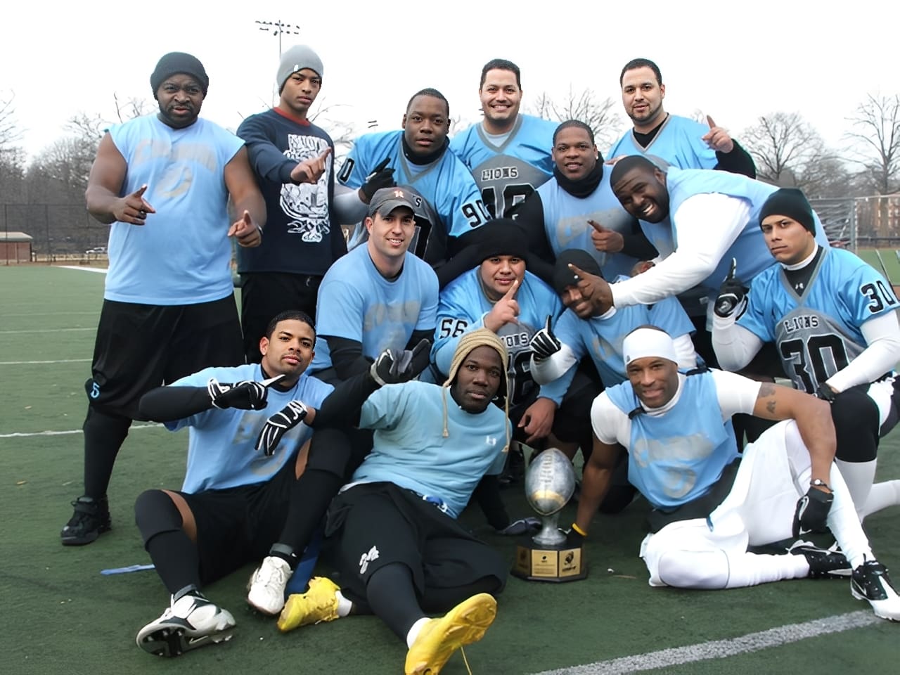 Football team celebrating with trophy