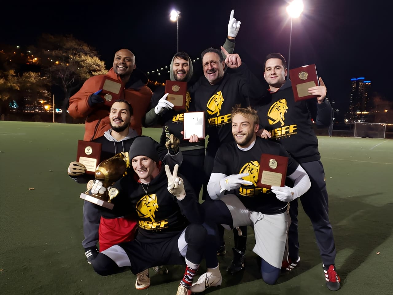 Group holding awards, smiling outdoors