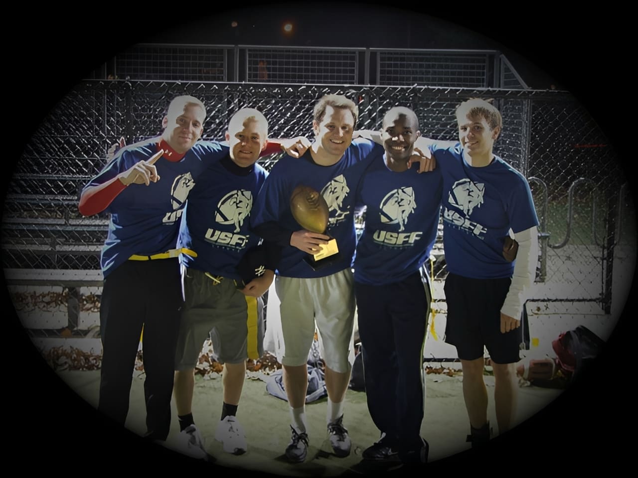 Team in blue shirts holding trophy