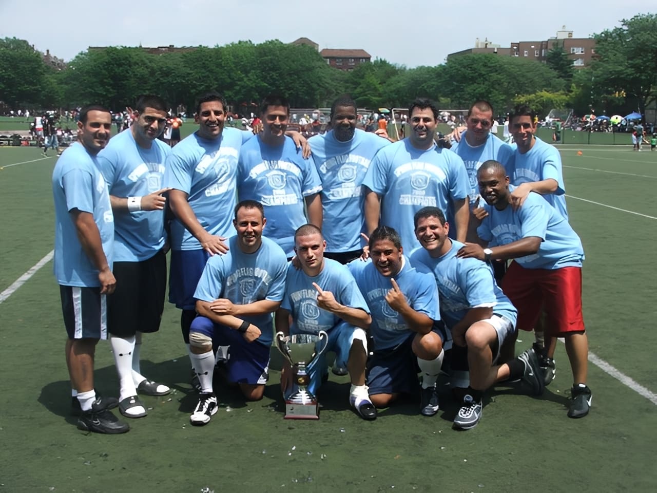 Team celebrating with trophy on field