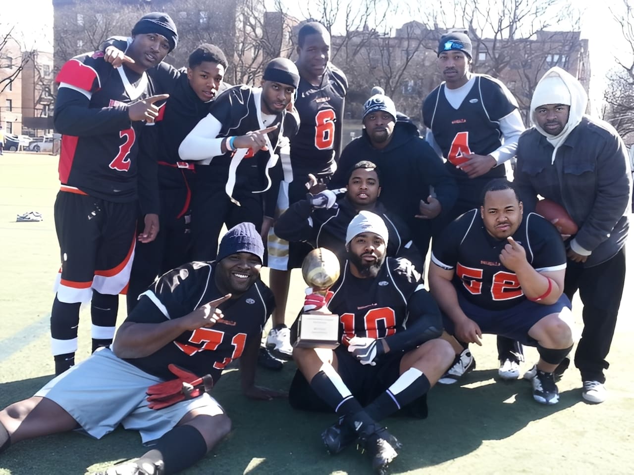 Football team celebrating with trophy