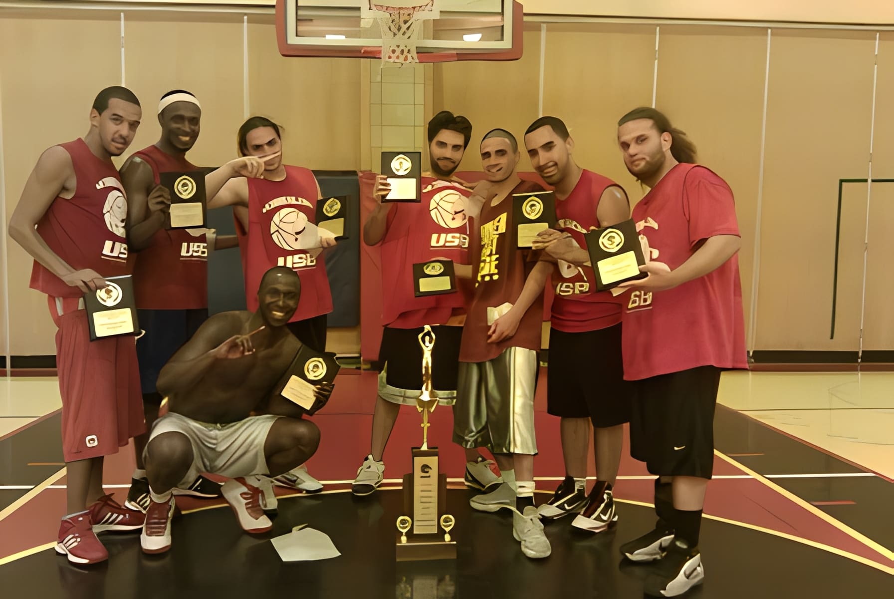 Team holding plaques on indoor court