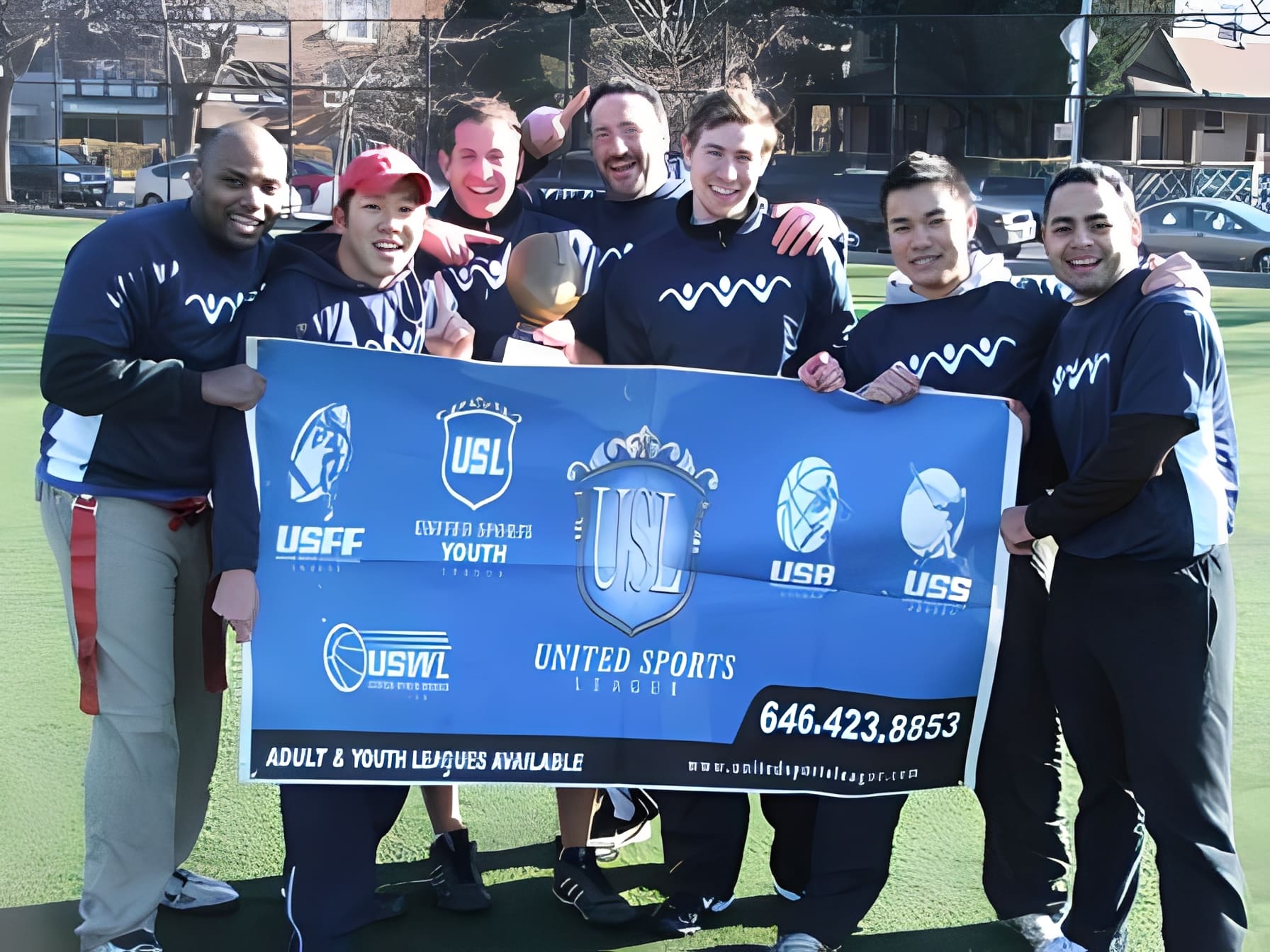 Group of players smiling with league banner