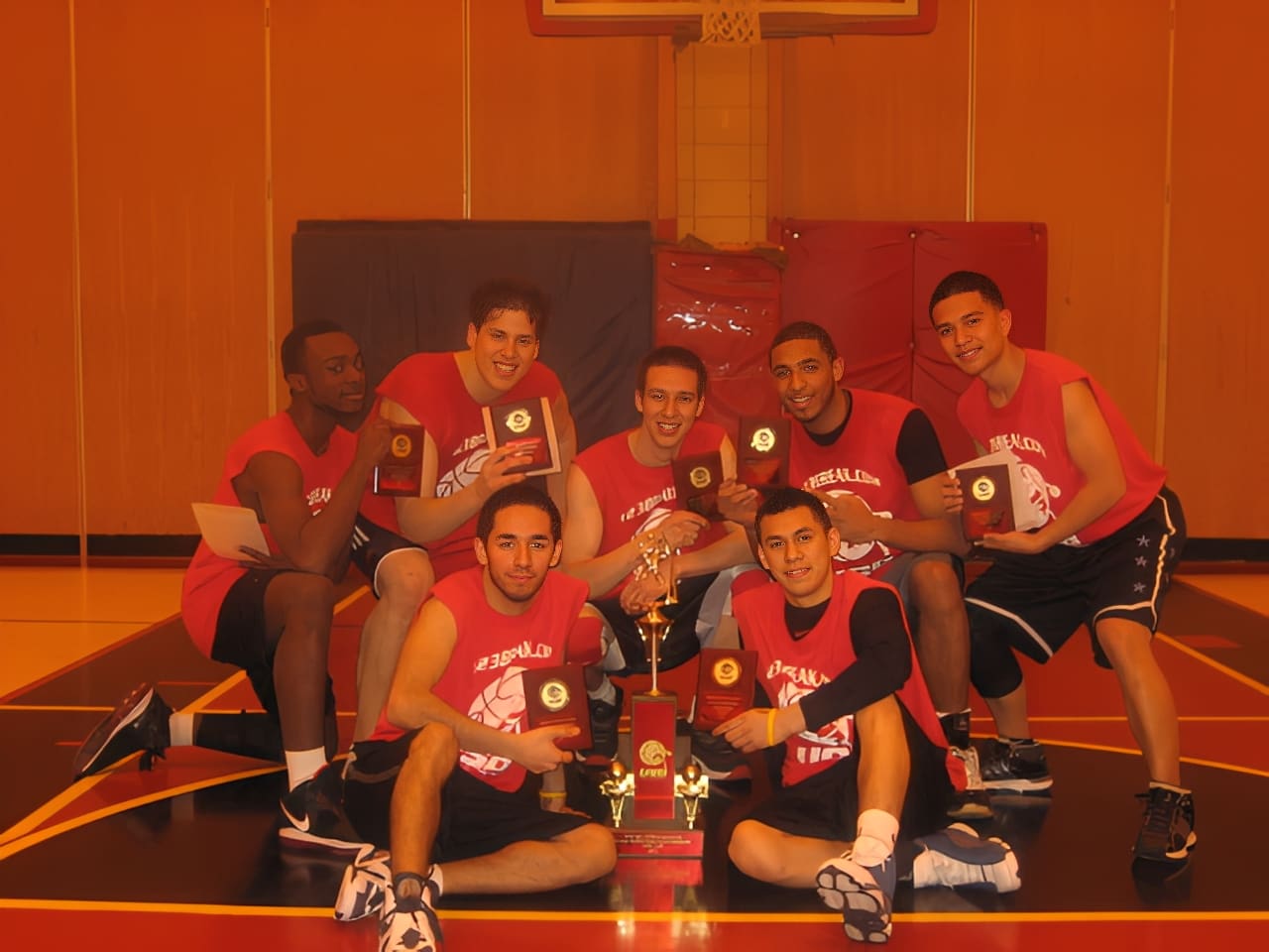 Basketball team celebrating with trophies