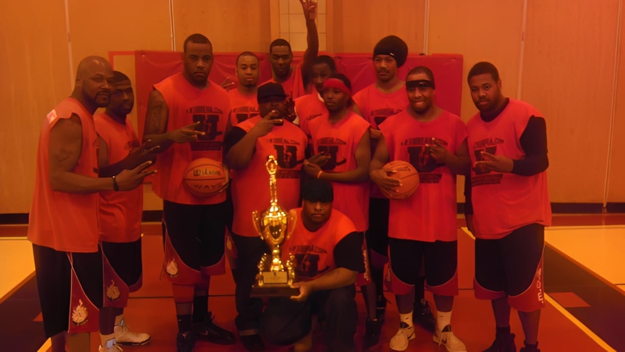 Team posing with basketballs and trophy
