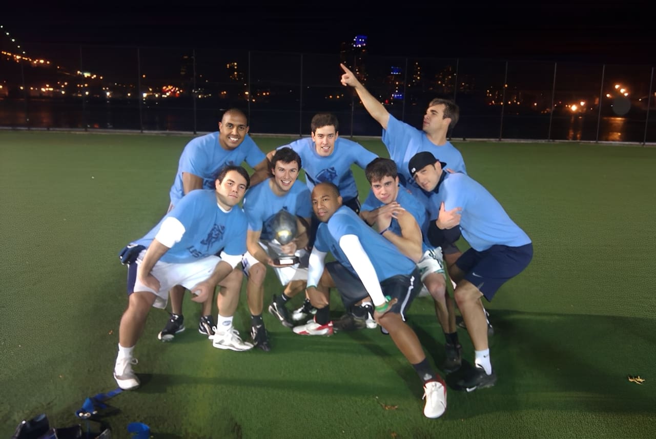 Group of friends posing with soccer ball